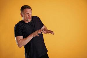 Disgusting, looking to the side, copy space. Man is against background in the studio photo