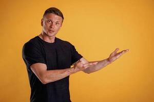 Copy ,space concept,, showing, pointing. Man is against background in the studio photo