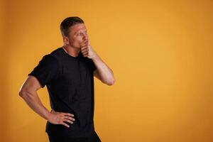 Thoughtful ,facial ,expression. Man is against background in the studio photo