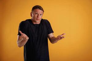 Confused, don't ,know what to do. Man is against background in the studio photo
