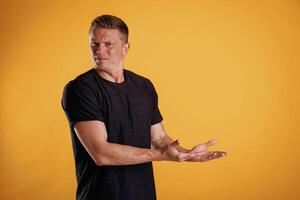 Invisible copy,, space, arms. Man is against background in the studio photo
