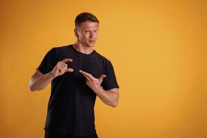 Banner in hands, copy space. Man is against background in the studio photo