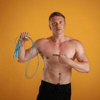 Blue,, jumping rope, fitness conception. Man is against background in the studio photo
