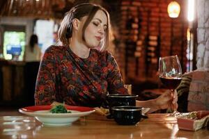 Big ,glass ,of ,wine, drinking. Woman is in the restaurant with food and drink photo