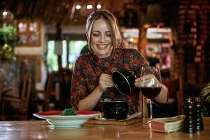Woman, is in the restaurant with food and drink photo