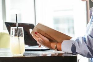 With, notepad. Beautiful woman with laptop is in the bar photo