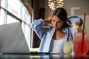 Front view. Beautiful ,woman with laptop is in the bar photo