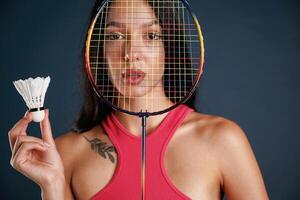 Hobby conception,,, badminton player. Beautiful young woman is against background photo