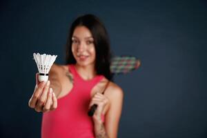 Hobby, conception,, badminton player. Beautiful young woman is against background photo