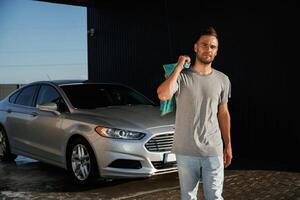 Front view, job, is,, done, polished. Man is with his car outdoors photo
