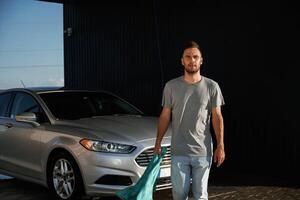 Front ,view, job, is,, done, polished. Man is with his car outdoors photo