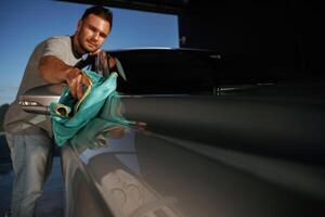 Job of ,car washing. Man ,is, with, automobile outdoors photo