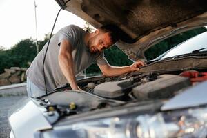 Problem, fixing and repairing the broken automobile. Man is with his car outdoors photo
