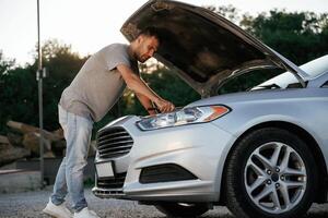 Problem, fixing ,,and ,repairing the broken automobile. Man is with his car outdoors photo