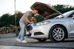 Problem,,,, fixing and repairing the broken automobile. Man is with his car outdoors photo