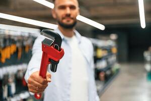 Selecting, the ,,new equipment. Man is in the hardware shop photo