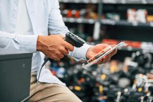 Cashier is ,at work. Man is in the hardware shop photo