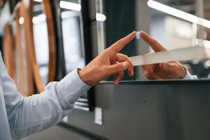 Smart mirror, touching ,it. Man ,is in the hardware shop photo