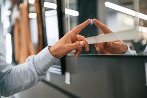 Smart mirror, touching it... Man is in the hardware shop photo