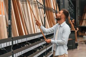 Warehouse ,with ,big choice of parquet. Man is in the hardware shop photo
