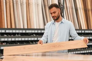 Warehouse,, with big, choice of parquet. Man is in the hardware shop photo