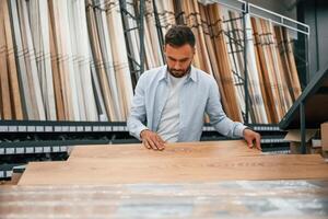 Parquet,, choosing.,, Man is in the hardware shop photo