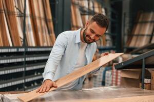 Warehouse with ,big ,choice of parquet. Man is in the hardware shop photo