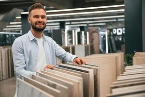 Bathroom,, tiles. Man is in the hardware shop photo