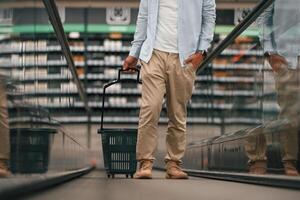 Handsome ,man is on the escalator in the mall photo