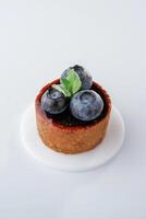 Made, by, professional baker. Delicious tart with blueberries against white background photo