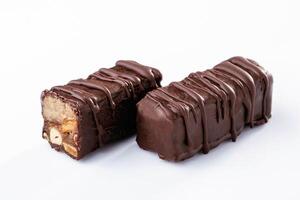 Chocolate bars lie on ,a ,white surface, isolated photo
