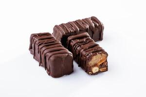 Chocolate bars lie on a white ,surface, isolated photo