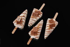 In the form of ice,, cream. Tasty ,cheesecakes on the black background photo
