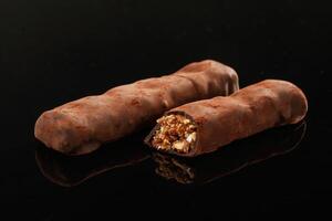 Close up view. Crispy, and ,sweet chocolate bars on black background photo
