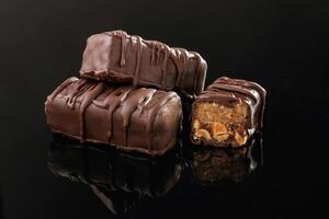 Close up ,view. Crispy and ,,sweet ,chocolate bars on black background photo