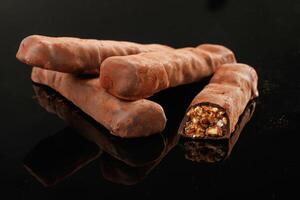 Crispy, and sweet chocolate bars on black background photo