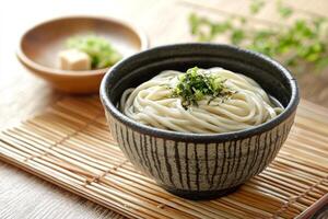 Soy sauce noodles in a bowl on a bamboo mat photo