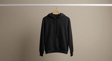Black Hooded Sweatshirt Hanging on a Rack in Studio photo