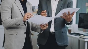 Two business men are holding papers and looking at each other video