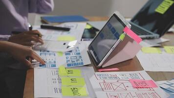 A person working on a laptop with sticky notes video