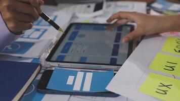 A person is using a tablet on a desk with sticky notes video