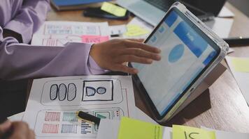 A person is using a tablet on a desk with papers and other items video