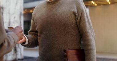 A gray-haired man of European appearance, dressed in a warm sweater, standing outdoors, close-up, motion to the man's face. in 4k, red komodo photo