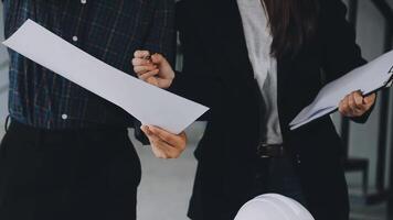 Two people in business attire holding papers and looking at each other video