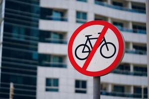 A traffic sign featuring a crossedout bicycle symbol is displayed in front of the building, indicating bicycles are not permitted on the premises photo
