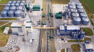 Modern industry on field. Grain processing factory with cargo trains and large metal grain elevators. View from above. video