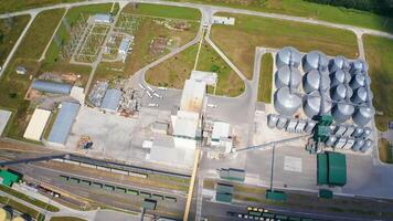 Construction of a new granaries on field. Grain elevators for keeping crop. Building of a modern agricultural complex. Top aerial view. video