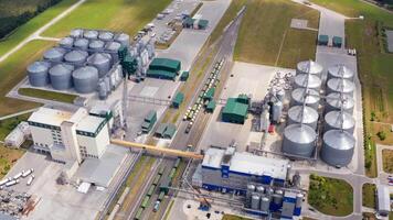 Contemporary agriculture complex. View from above on industry with large storage bins for keeping crop. Freight trains and grain elevators on field. Top view. video