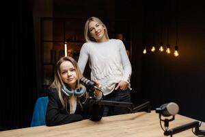 Two podcasters gesturing ok sign during a live recording. photo
