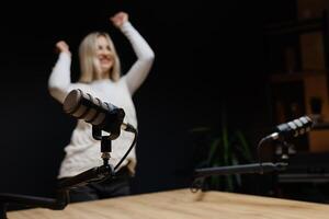 Podcaster dancing and laughing during a recording session. photo